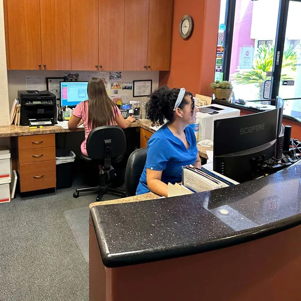 Office staff sitting at the front desk at Buena Vida Dental Studio